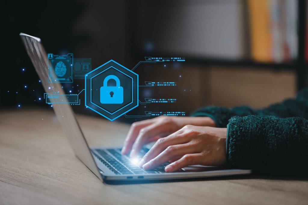Remote worker using a secure laptop with VPN and cybersecurity tools to protect data while working from home.