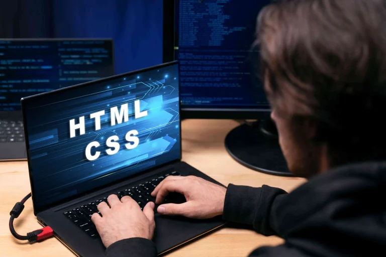 Business professionals reviewing programming languages for web development in 2026, comparing JavaScript, Python, Go, and enterprise technologies to choose the best solution for scalability.
